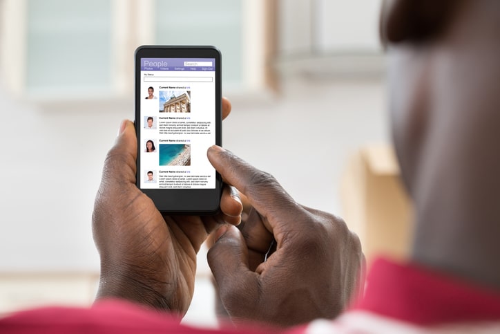 African American man on social media on phone