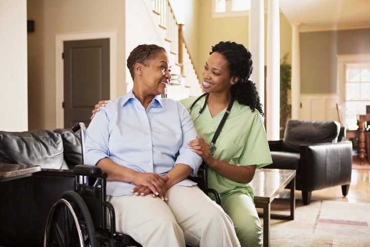 African American woman in wheelchair with nurse