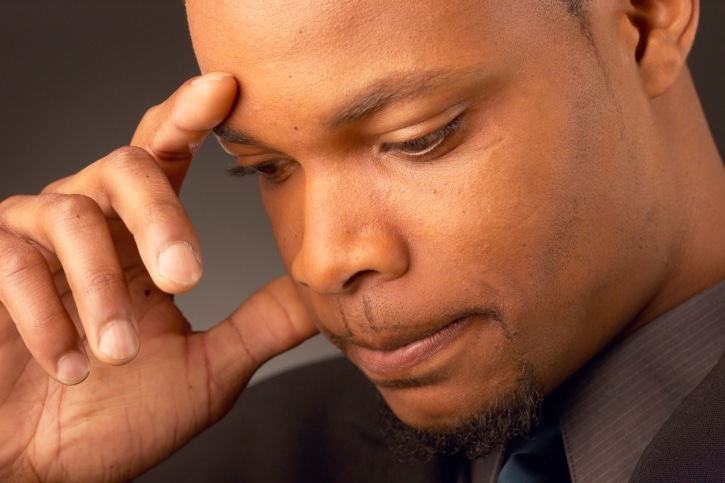 African American man looking down serious frustrated