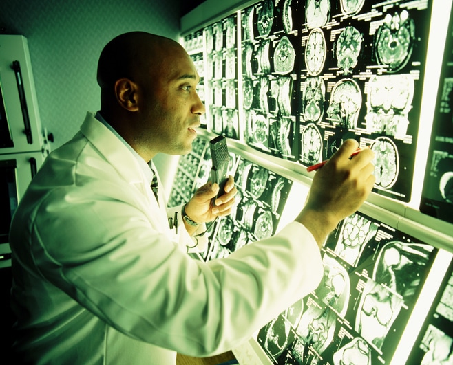 African American doctor looking at MRI scans