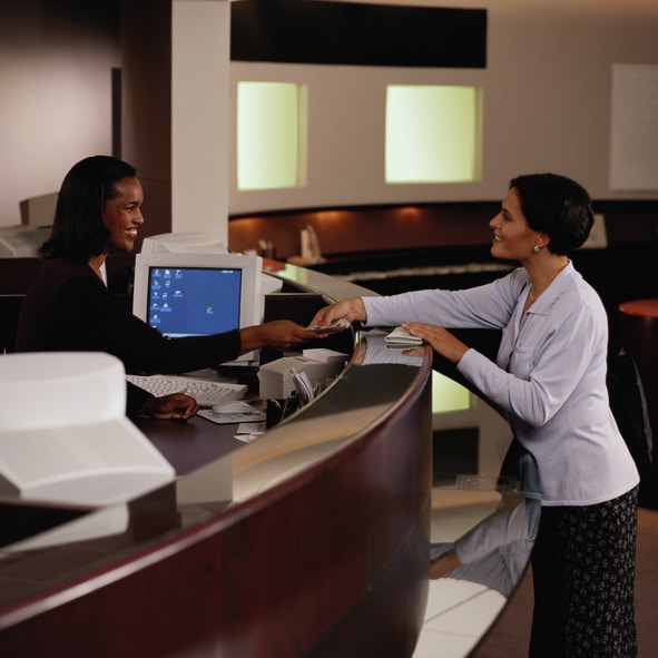 Teller Handing Woman Money at a Bank