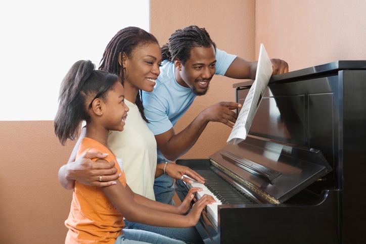 African American family playing piano