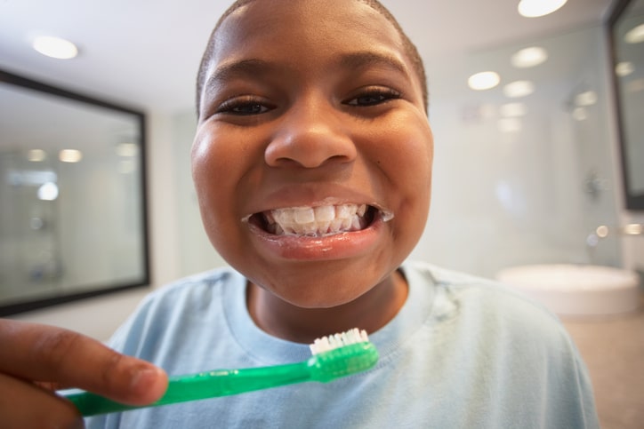 African American boy brushing teeth