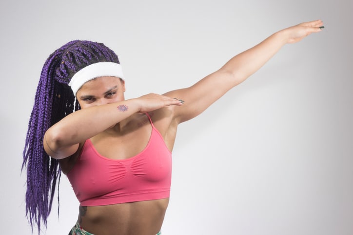 African American woman with braids dab dance