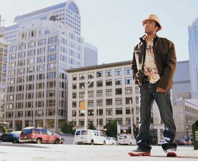 African American man standing on city sidewalk
