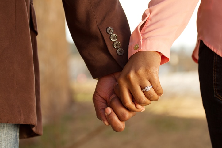 African American couple holding hands engaged