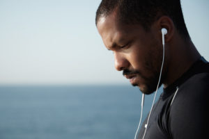 African American man stressed listening to music
