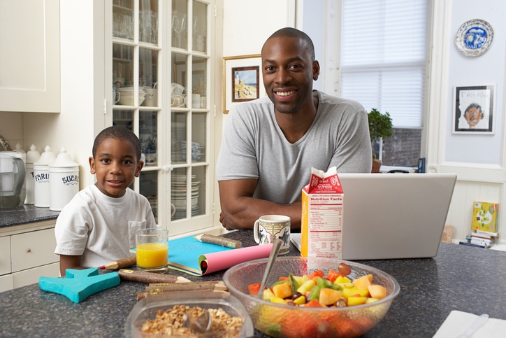 African American father and son breakfast in kitchen