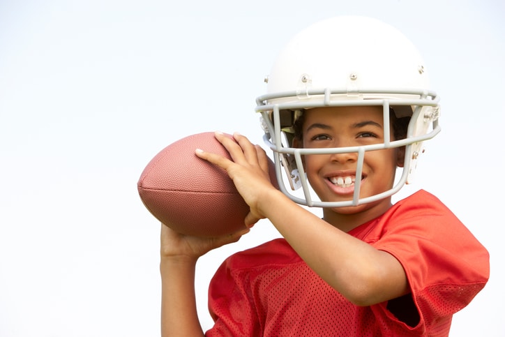 African American boy playing football
