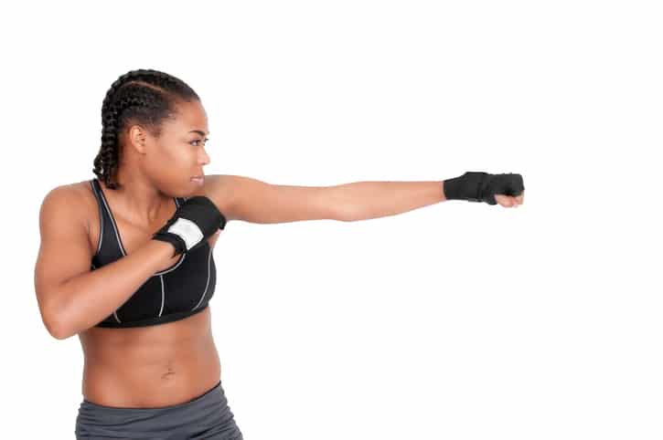 African American woman with braids boxing
