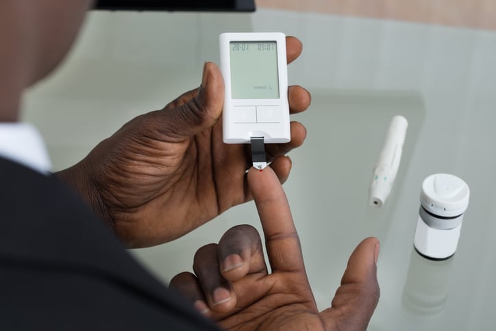 African American man testing blood sugar diabetes