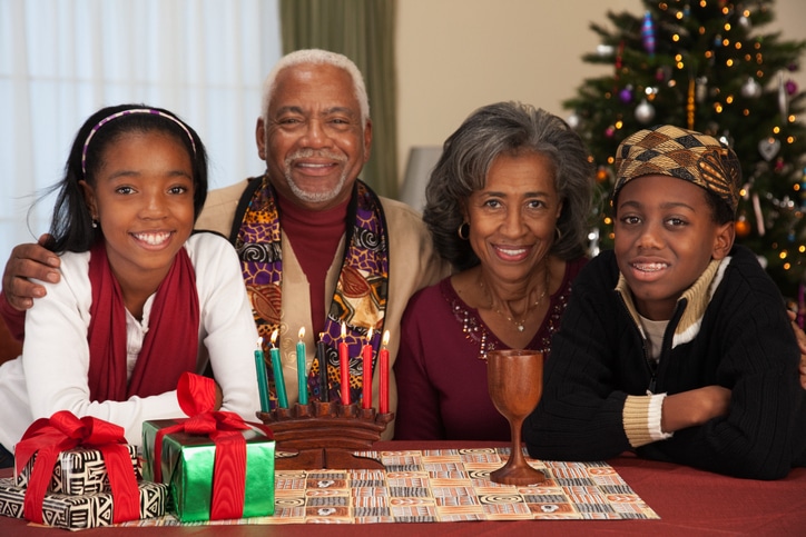 African couple with grandchildren celebrating Kwanzaa