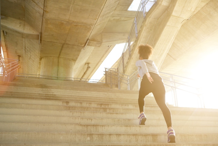 woman running up stairs