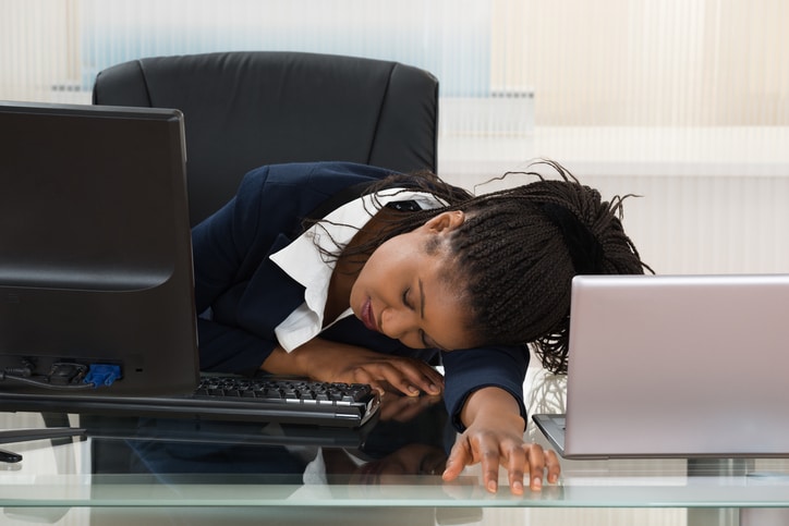 African American woman sleeping at desk