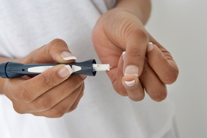 Woman injecting insulin