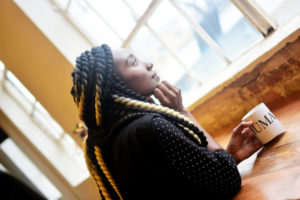 African American woman looking out window