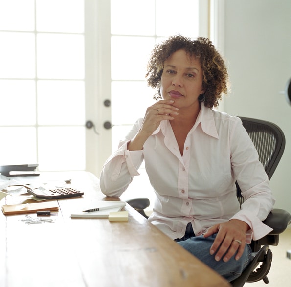 Mature African American woman home office serious