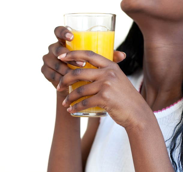 African American woman drinking orange juice