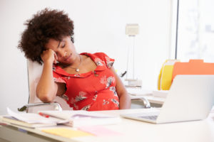 African American woman sleeping at work