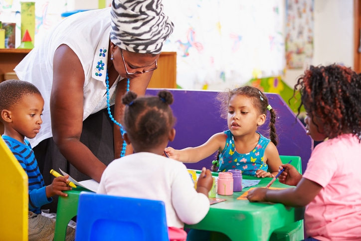 African American preschool children and teacher in school