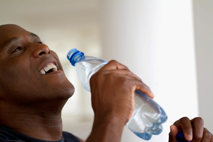 African American man drinking bottle water