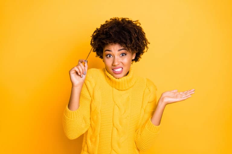 Photo of trendy misunderstanding dandruff haired girlfriend wearing yellow jumper not knowing how to care about hair while isolated with bright color background, how to take care of black male hair