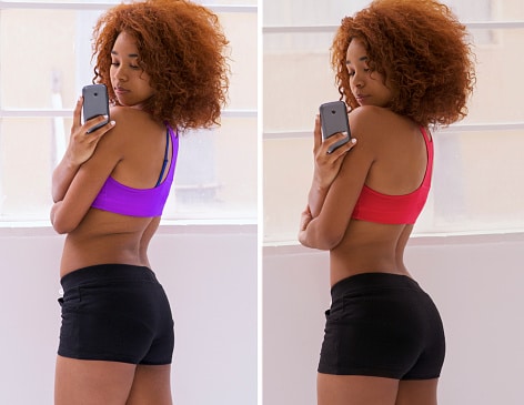 Black woman looking at her butt.