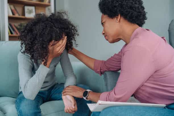 a woman comforting a crying woman